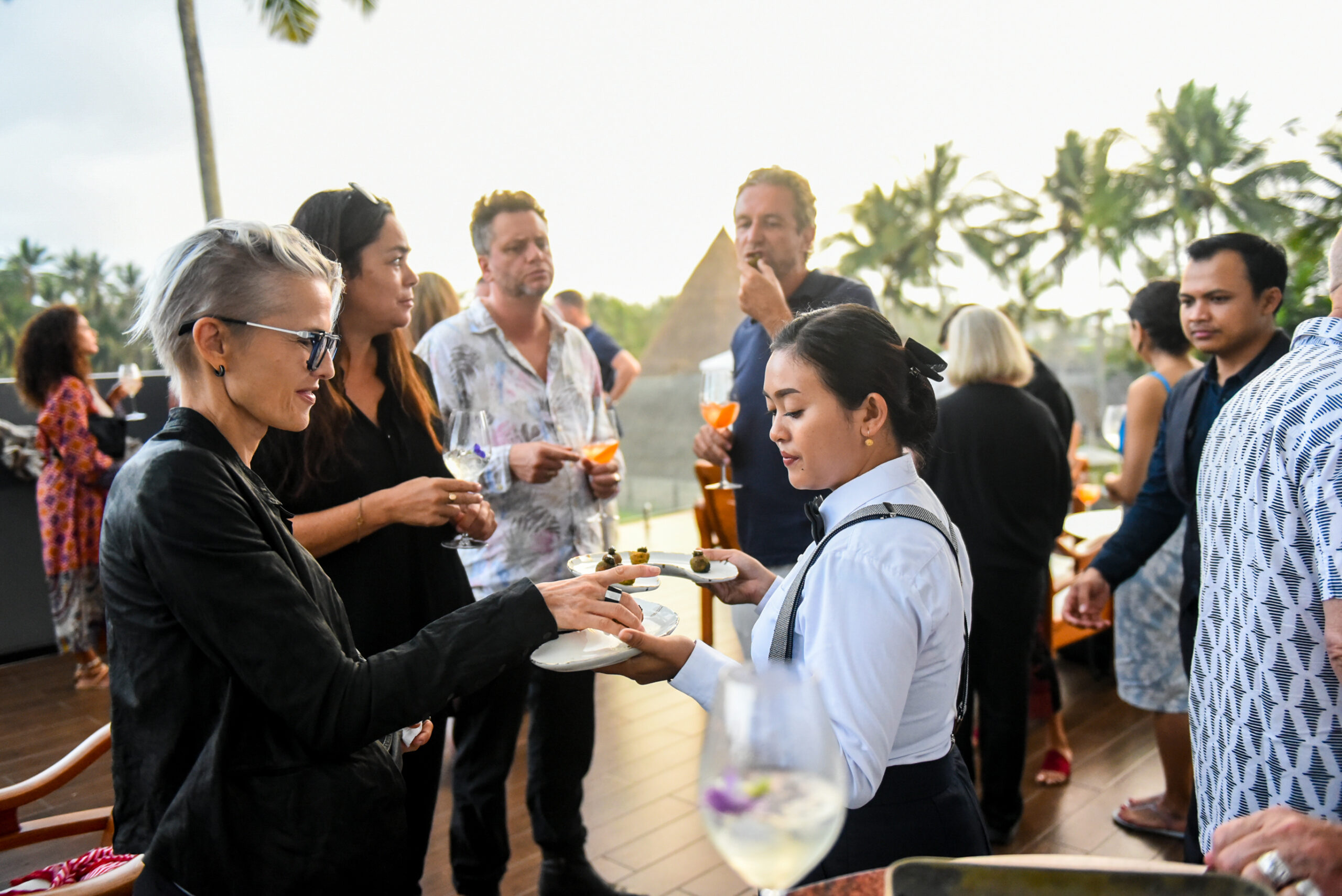 A caterer serving guests at a Bali event